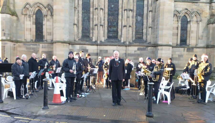Band gathered outside Hexham Abbey